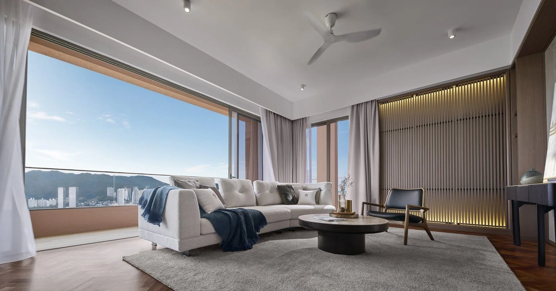 Living area at The Lume by E&O with panoramic sea views and spacious open-plan layout.