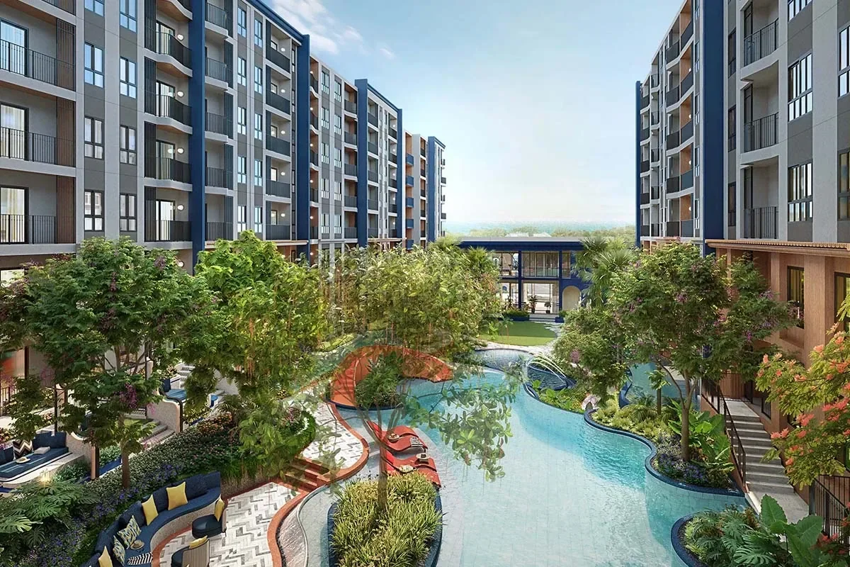 Resort-style coastal swimming pool at Cabanas Hua Hin surrounded by landscaped gardens and residences.