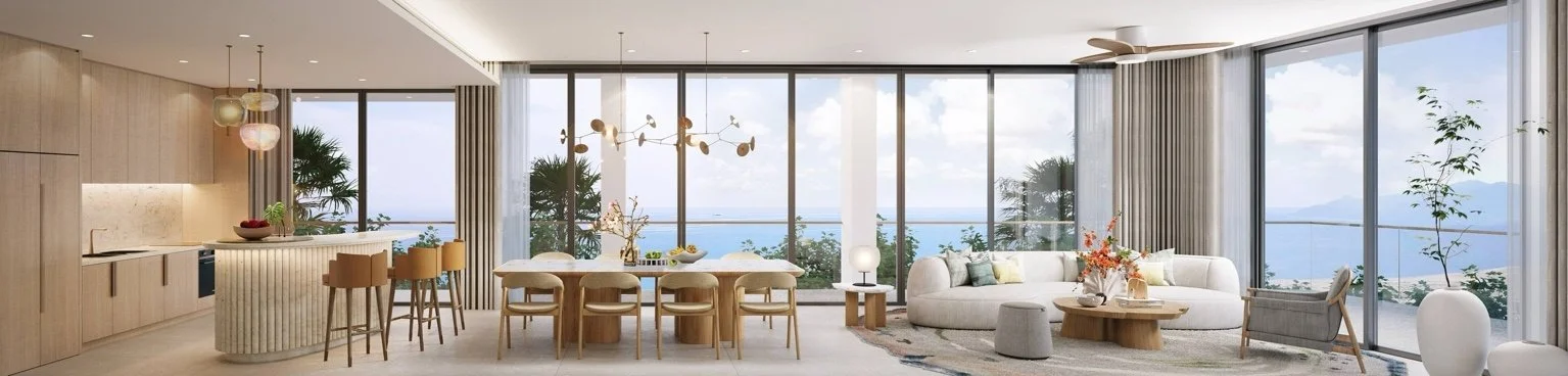 Open-plan living and dining area with full-height glazing and sea view at Gardens of Eden Phuket, featuring an island kitchen and lounge seating.