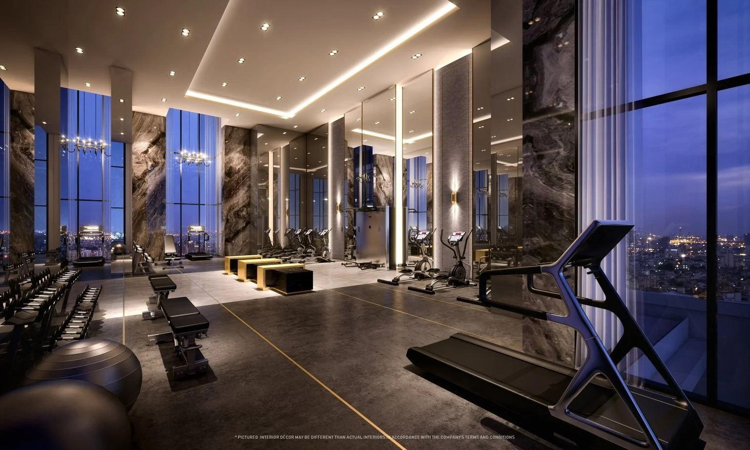 Cloud Fitness gym at The Address Siam–Ratchathewi at night with panoramic city views and high-spec training equipment.