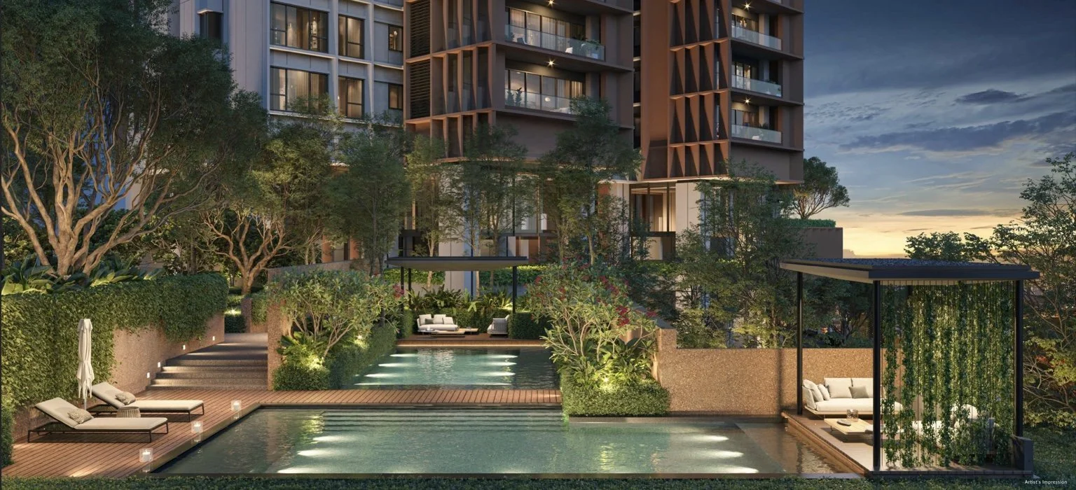 Evening view of the pool and landscaped deck at The Lume by E&O with garden lighting and outdoor lounge areas.