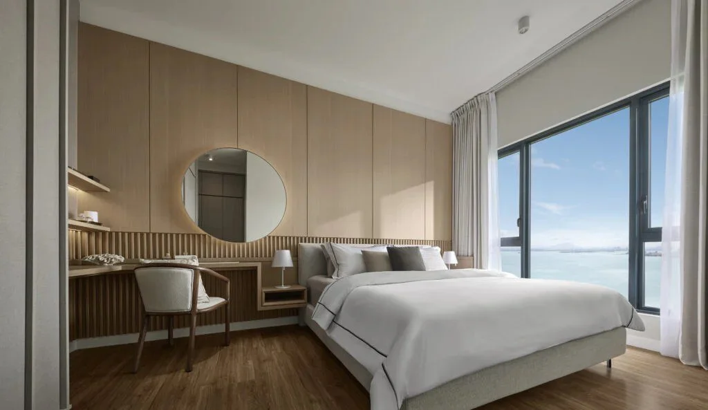 Master bedroom at Maris with warm timber finishes and sea views