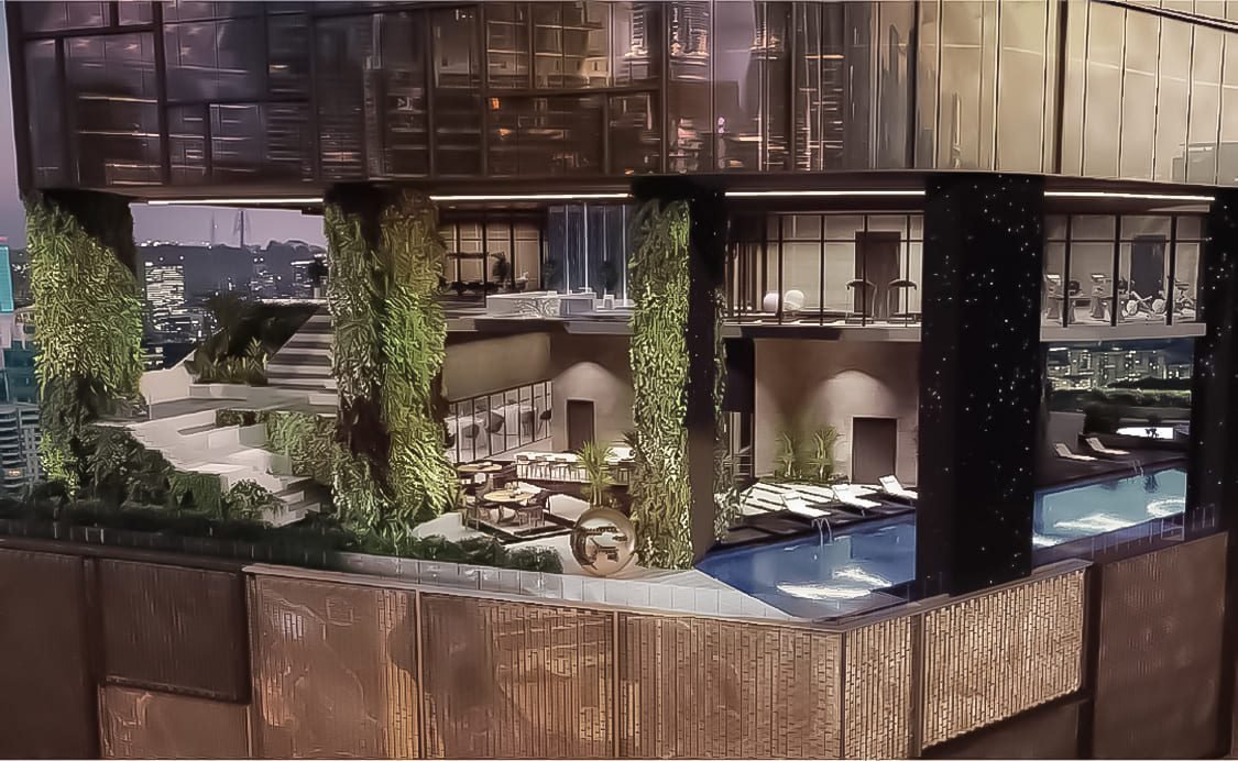 Infinity pool at Orion Residence overlooking Kuala Lumpur’s skyline with ambient lighting.