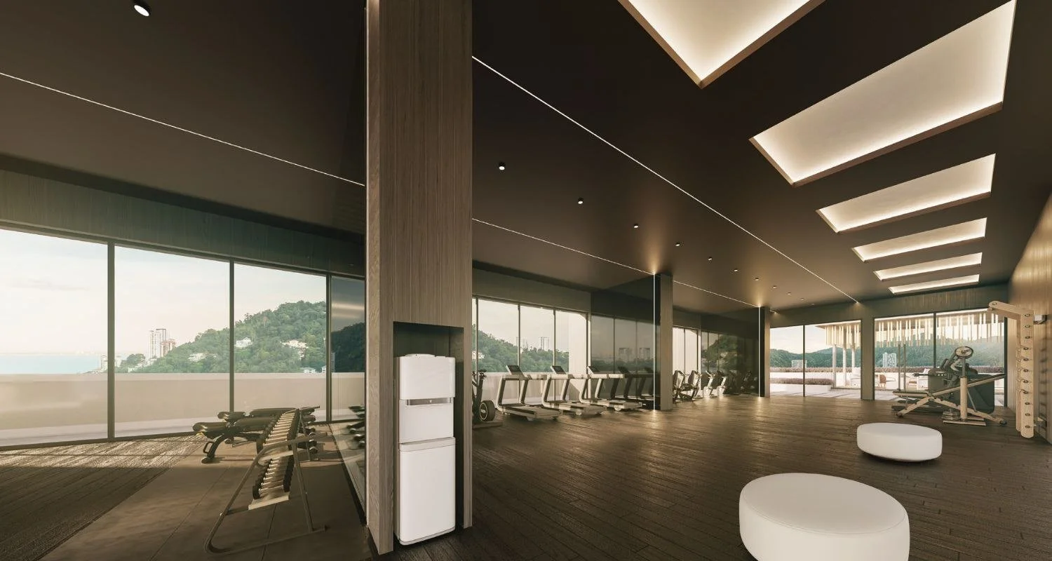 Sky Vista gym at Waterstone Penang with floor-to-ceiling glazing and hillside views.
