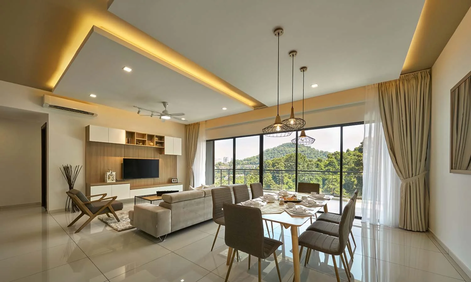Open-plan dining and living area in Alila² Penang Type B1 unit with full-height sliding doors and hillside views.
