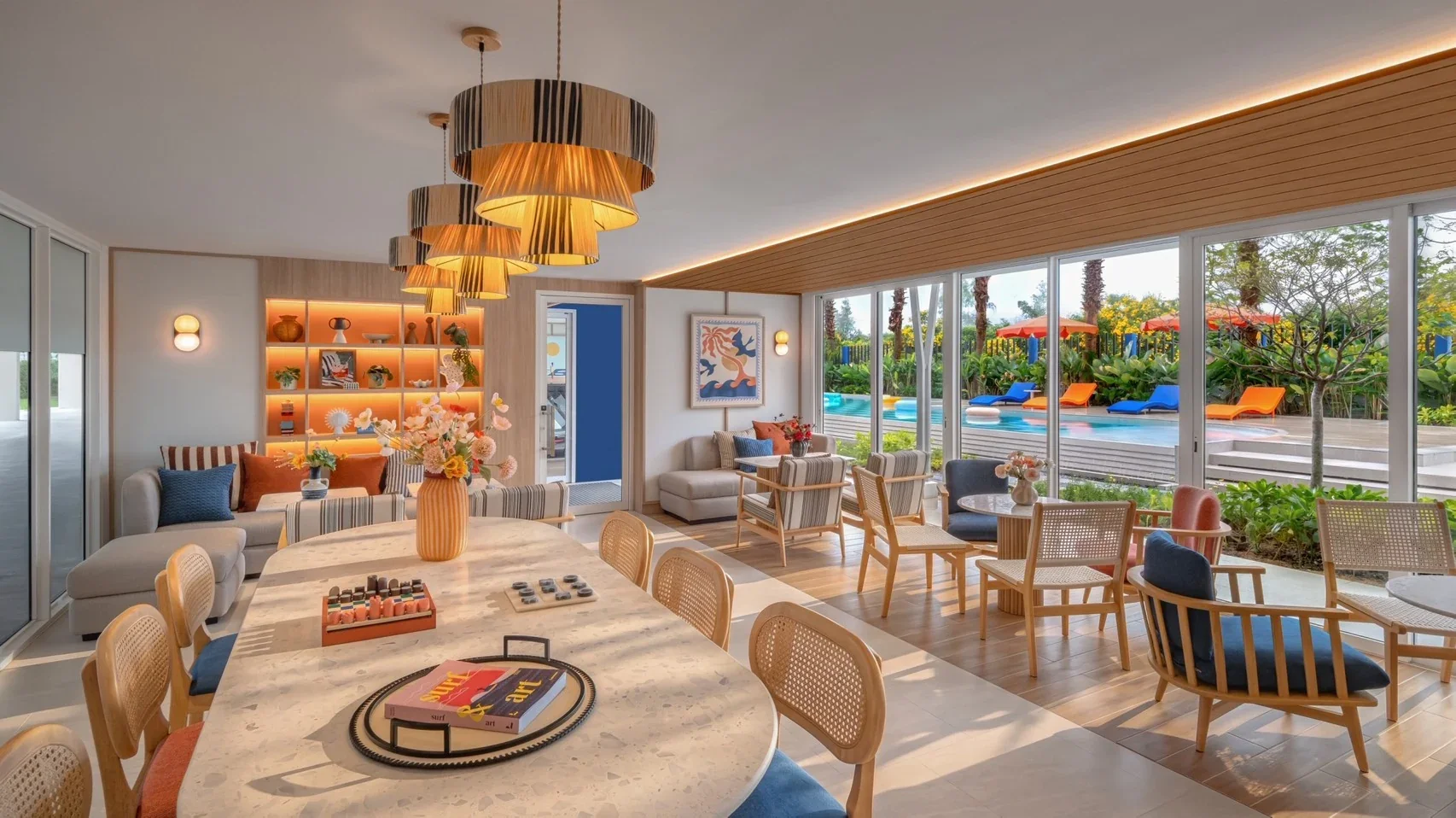 Residents’ lounge at Hub Hua Hin with seating areas overlooking the swimming pool.