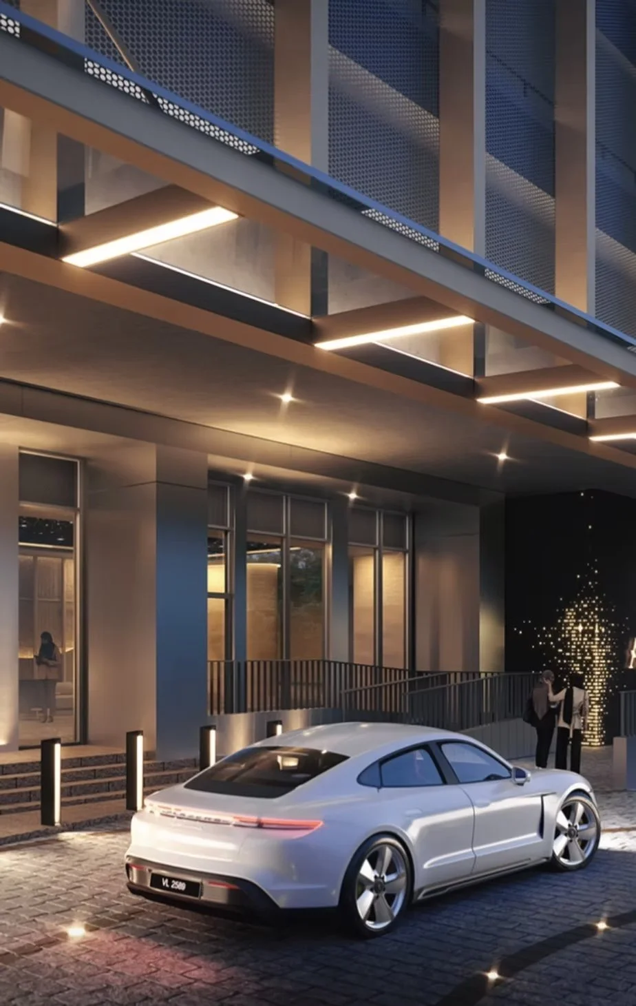 The Arden arrival drop-off area at night with covered entrance and driveway.