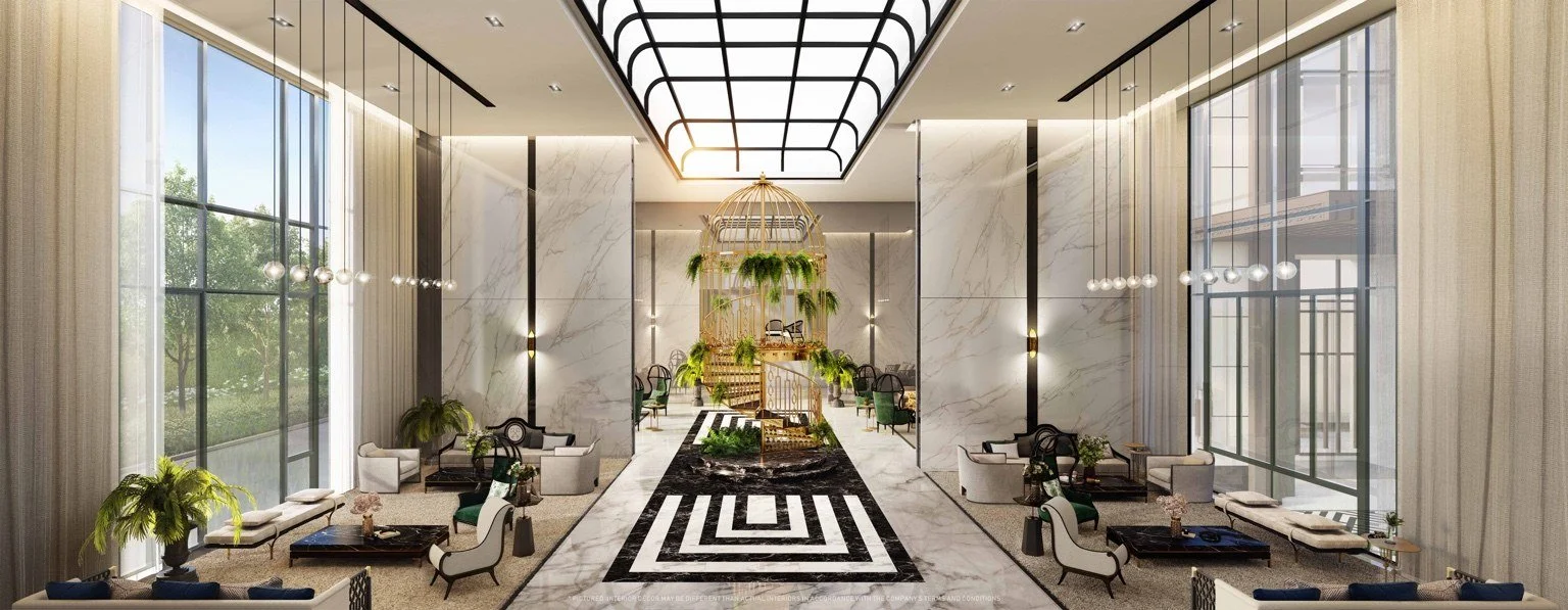 The Grande Chamber atrium at The Address Siam–Ratchathewi with double-height ceilings, marble surfaces and central feature staircase.