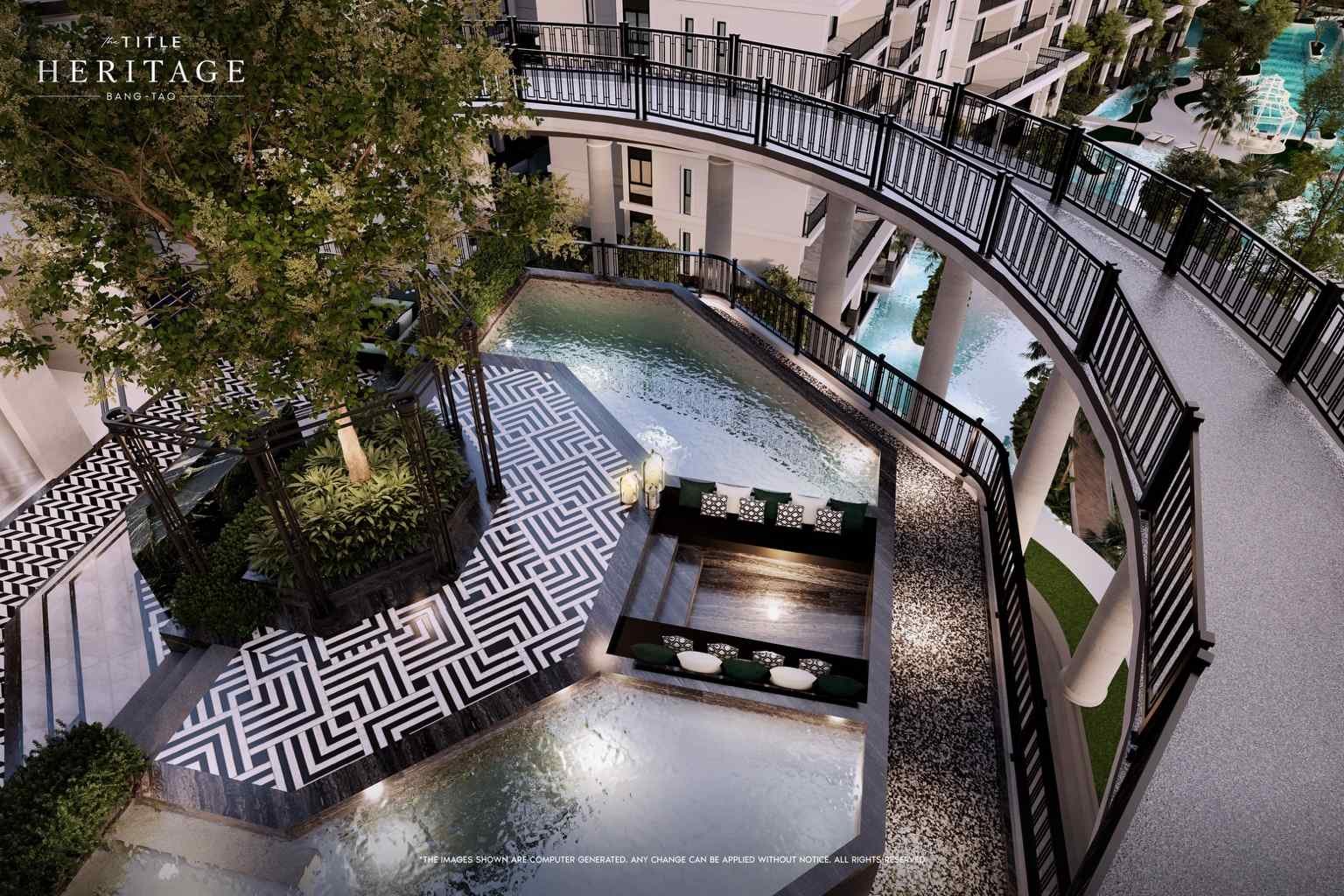 Rooftop onsen-style pool with landscaped edging and evening lighting at The Title Heritage Bang Tao.