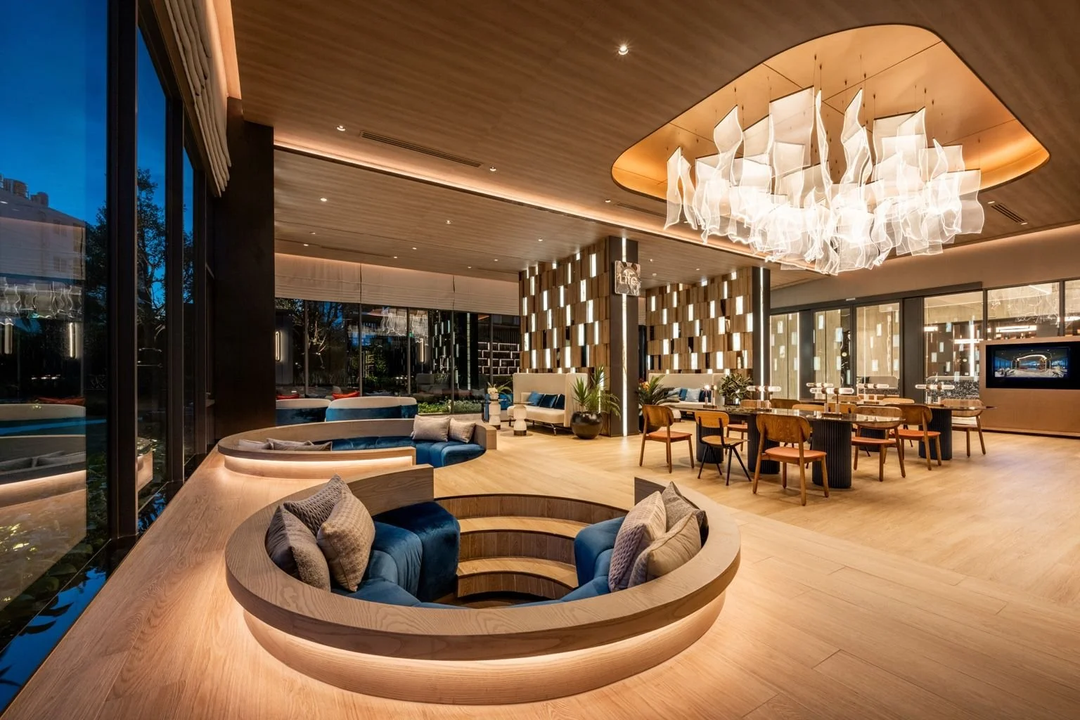 Social lounge and playfulness bar area at Life Rama 4 Asoke with contemporary seating and ambient lighting.