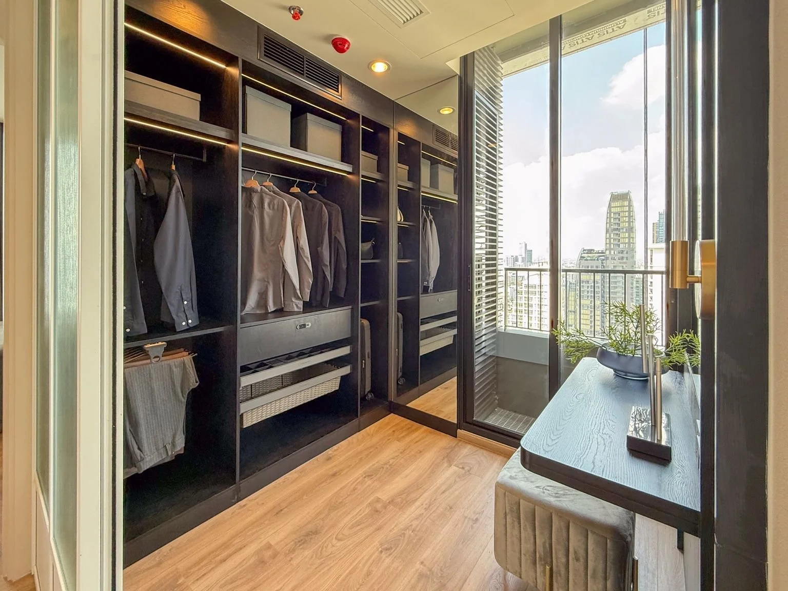 Walk-in wardrobe at Noble Form Thonglor with fitted storage and balcony access.