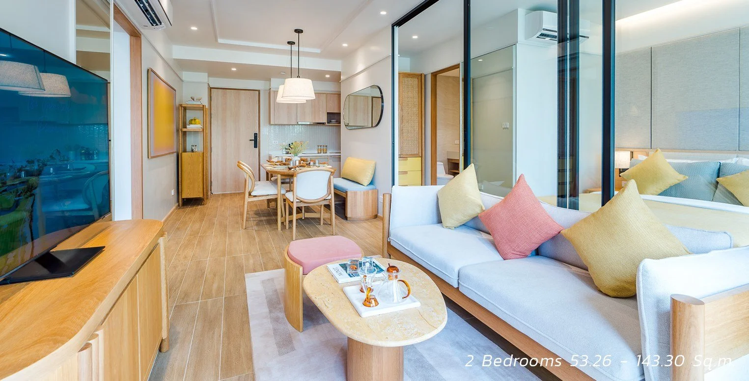 SASA Hua Hin two-bedroom condo open-plan living area with adjoining bedroom.