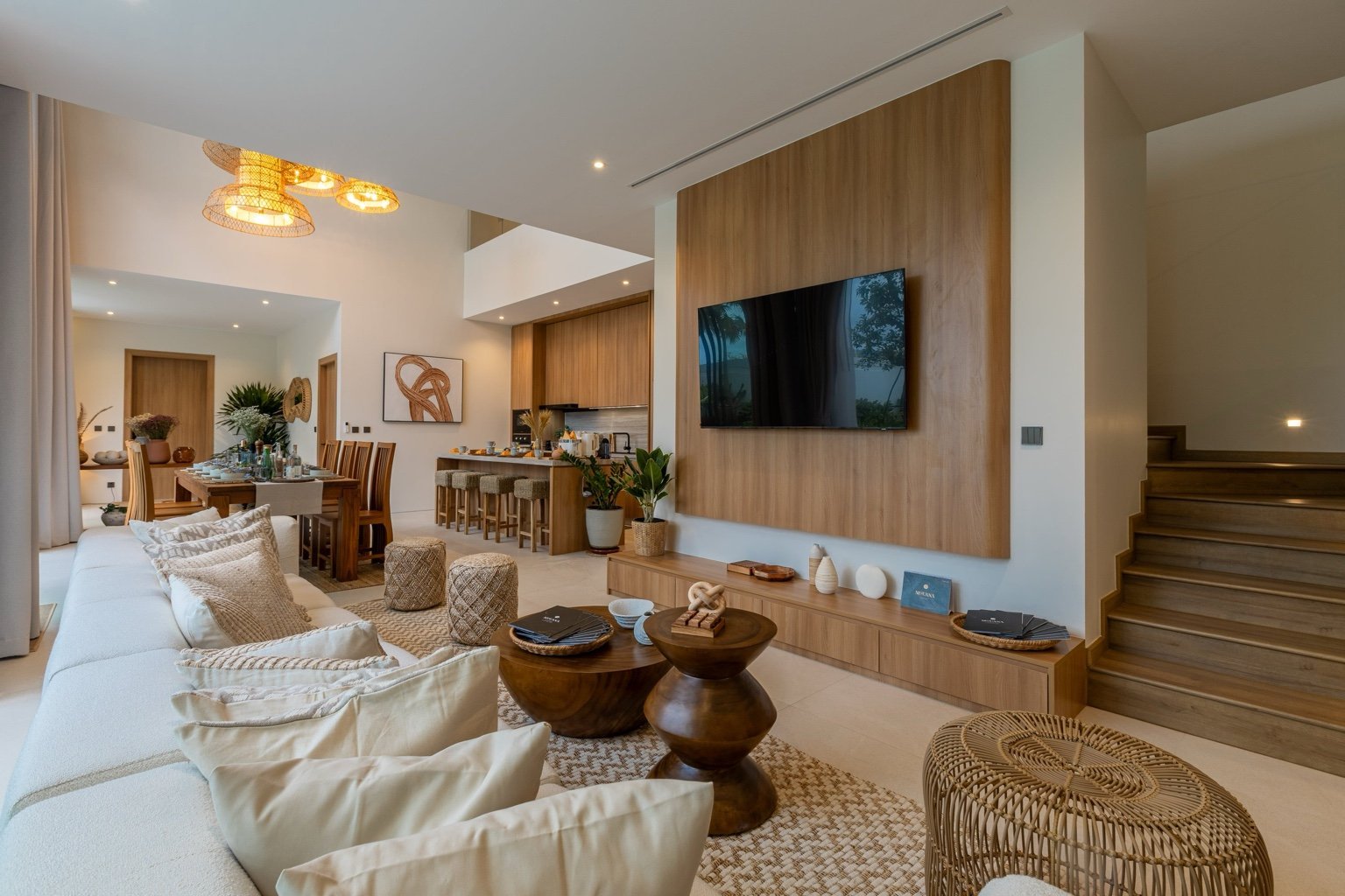 Spacious open-plan living room at Mouana Grande Chalong Bay with high ceilings and pool access.