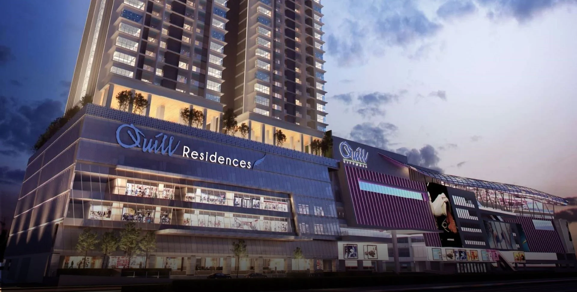 Exterior night shot of Quill Residences Kuala Lumpur with glass frontage and city lights.