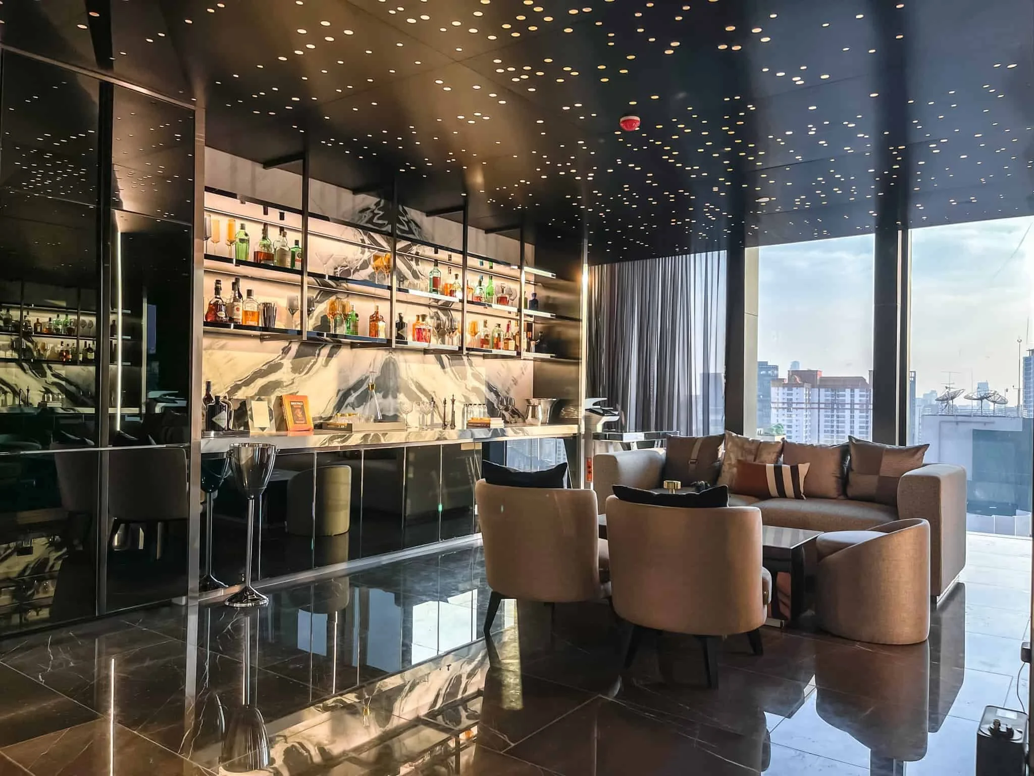 Luxury sky lounge seating and bar area at Park Origin Phayathai Bangkok.