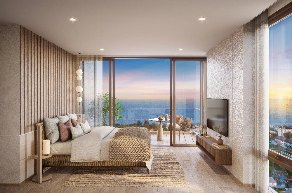 Bedroom interior at Vehha Hua Hin with sunset sea views and balcony access in Hua Hin, Thailand.
