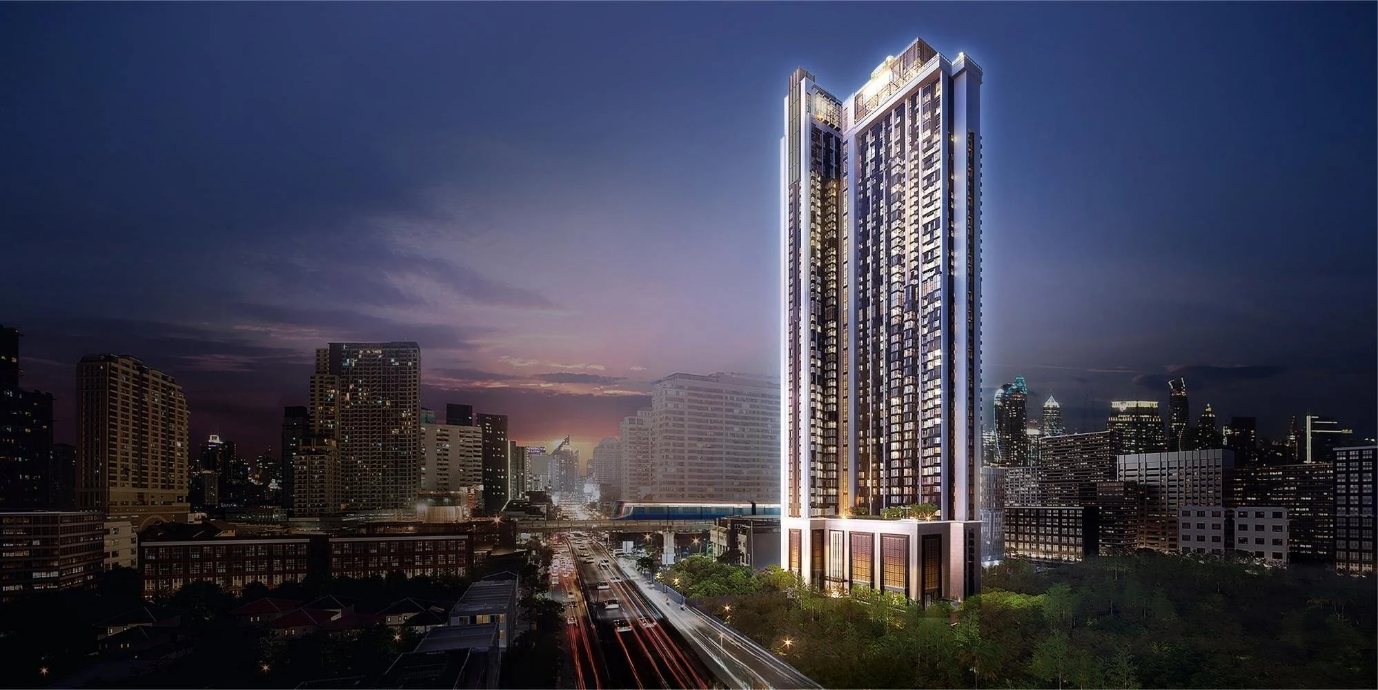 The Address Siam–Ratchathewi tower illuminated at night in central Bangkok.