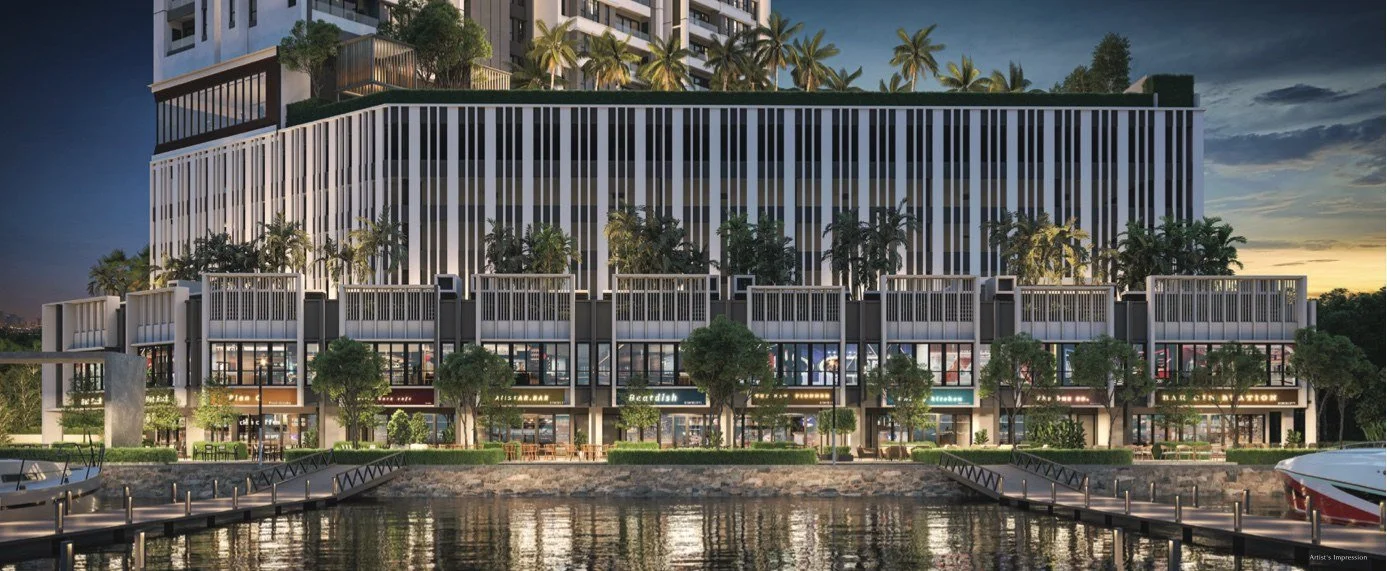 Marina-facing retail and dining promenade at Maris Penang in the evening.