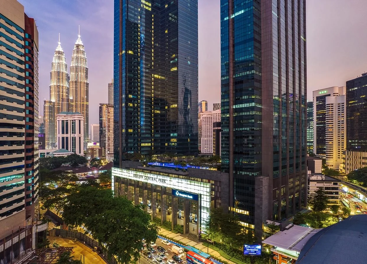 Ritz Carlton Residence at night with partial swimming pool view and Pertronas Towers in the background illuminated.