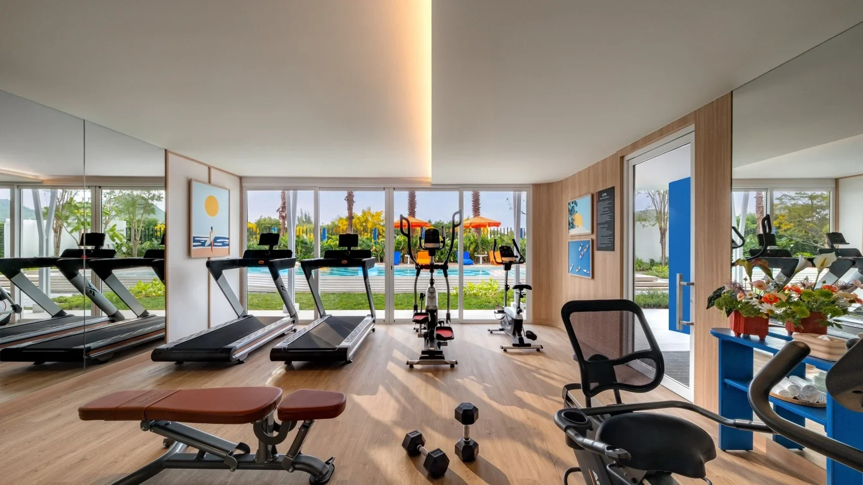 Fitness centre at Hub Hua Hin overlooking the landscaped swimming pool.