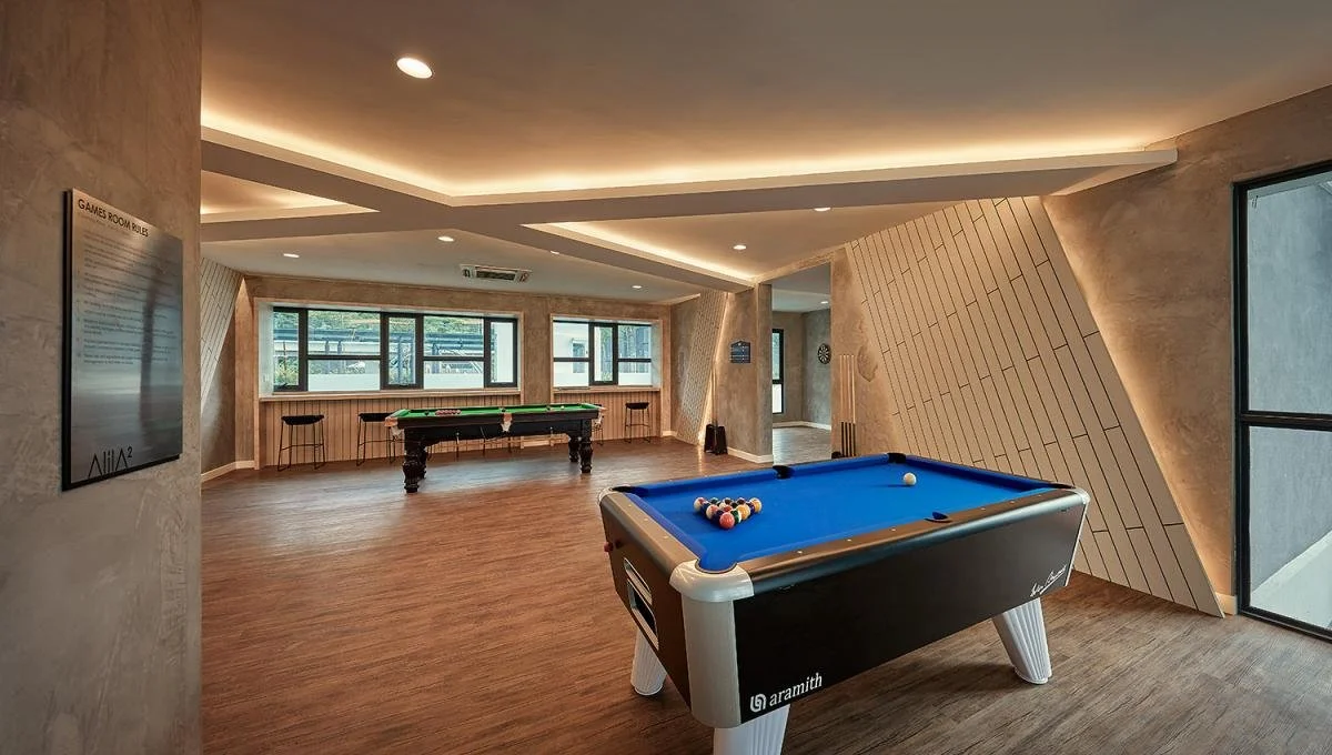 Indoor games room with pool tables at Alila² condominium.
