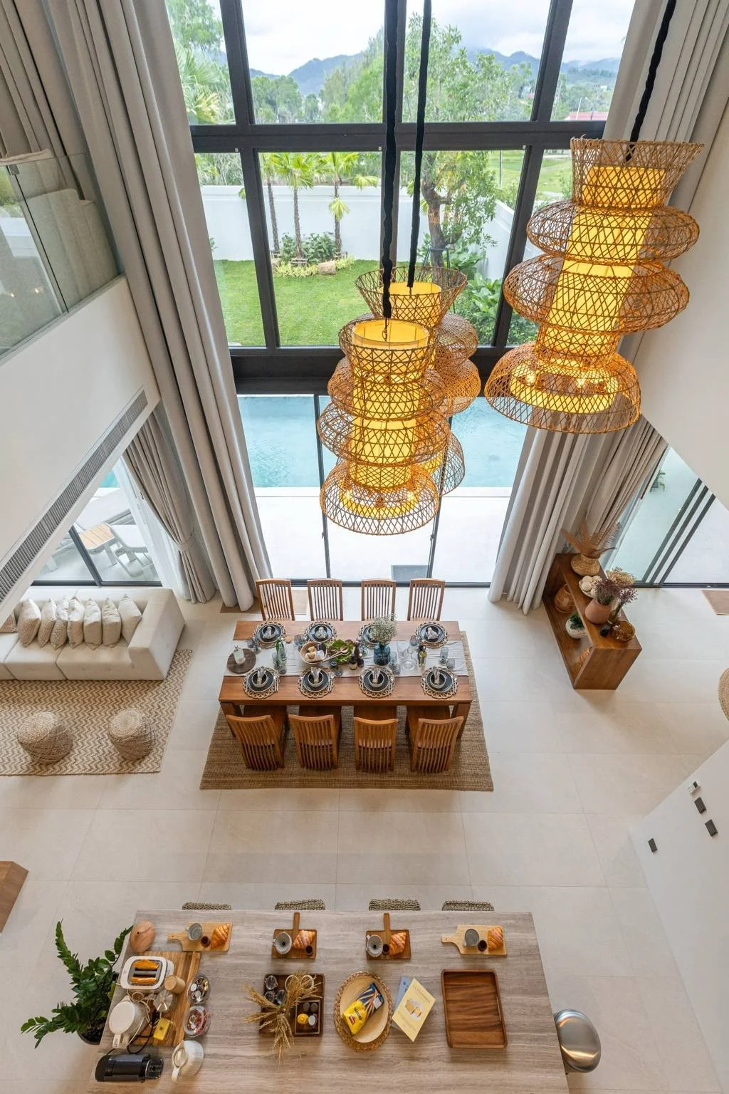 Overhead view of the dining room at Mouana Grande Chalong Bay villa in Phuket with pool and garden views.