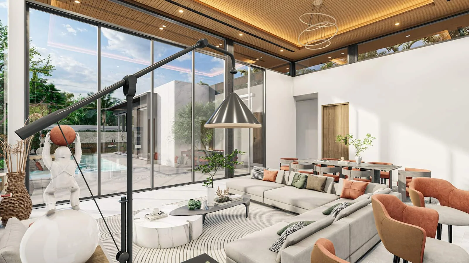 Mouana Serenity open plan lounge with a lamp in the foreground, a corner sofa, facing flour to high ceiling class sliding doors looking out onto private pool