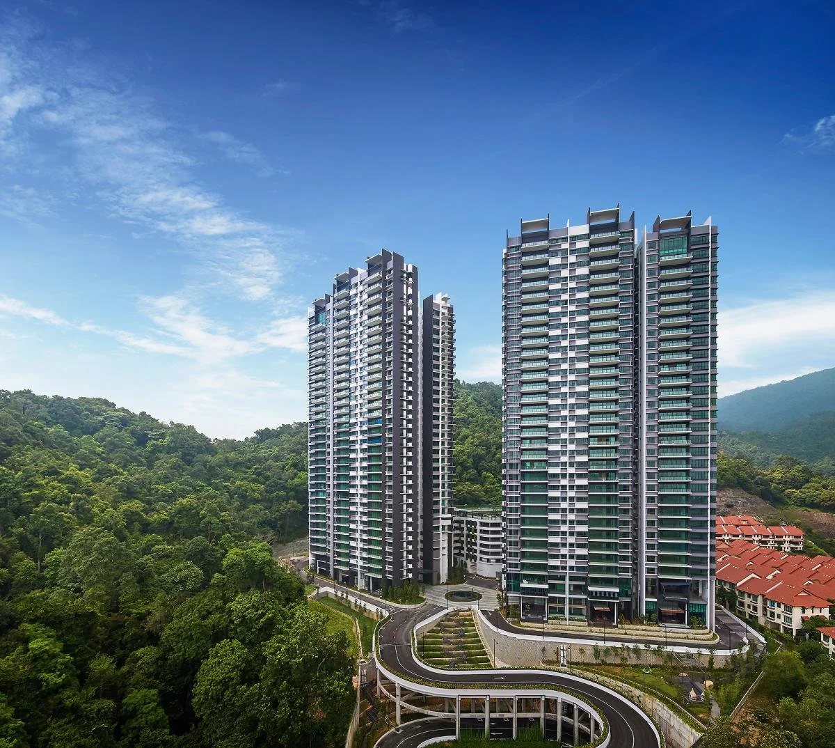 Alila² twin residential towers set against forested hillside in Tanjung Bungah.