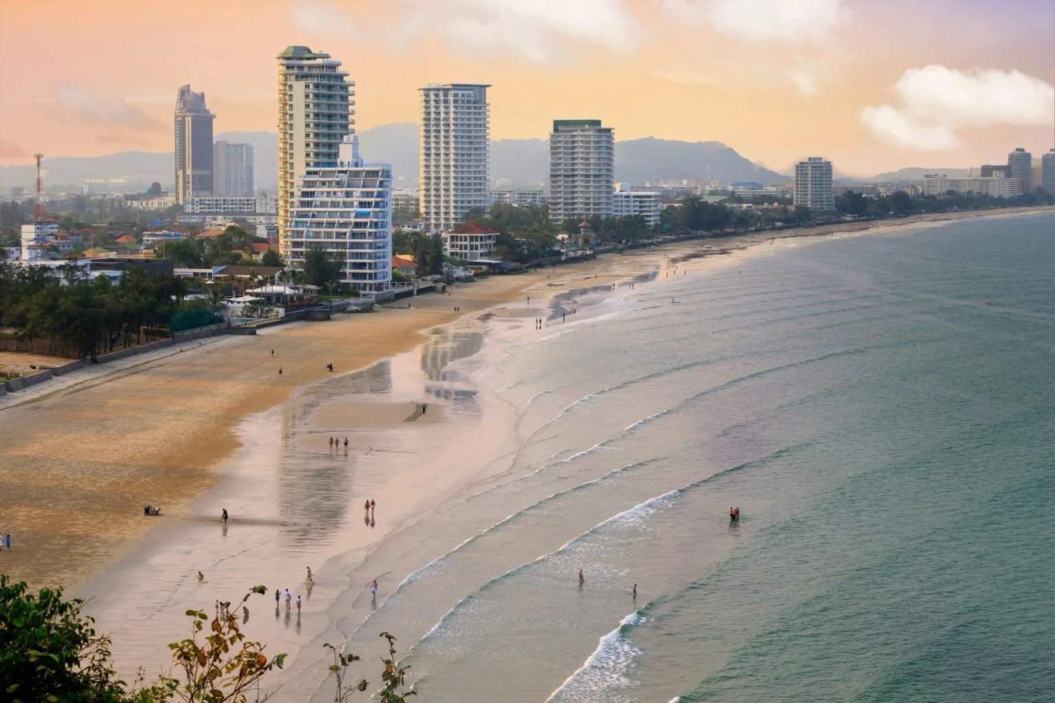 Aerial view of Hua Hin beach coastline and town in the background.