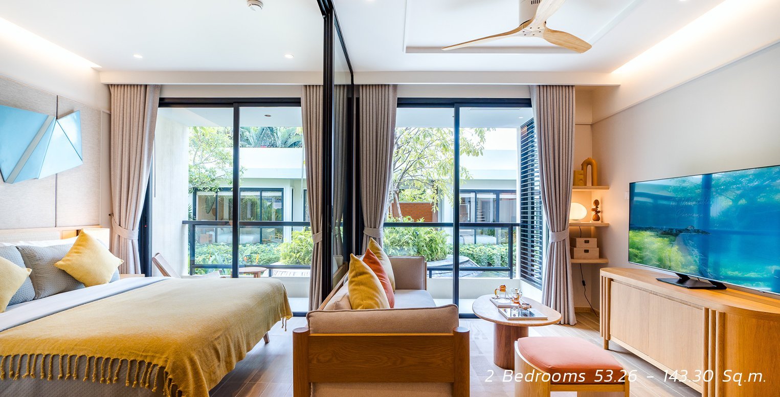 SASA Hua Hin two-bedroom condo interior with bedroom, living area and balcony.
