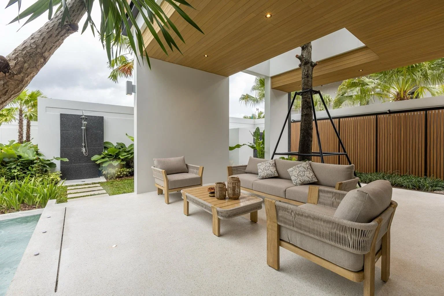 Covered outdoor seating area beside the pool at Mouana Grande Chalong Bay, Phuket.