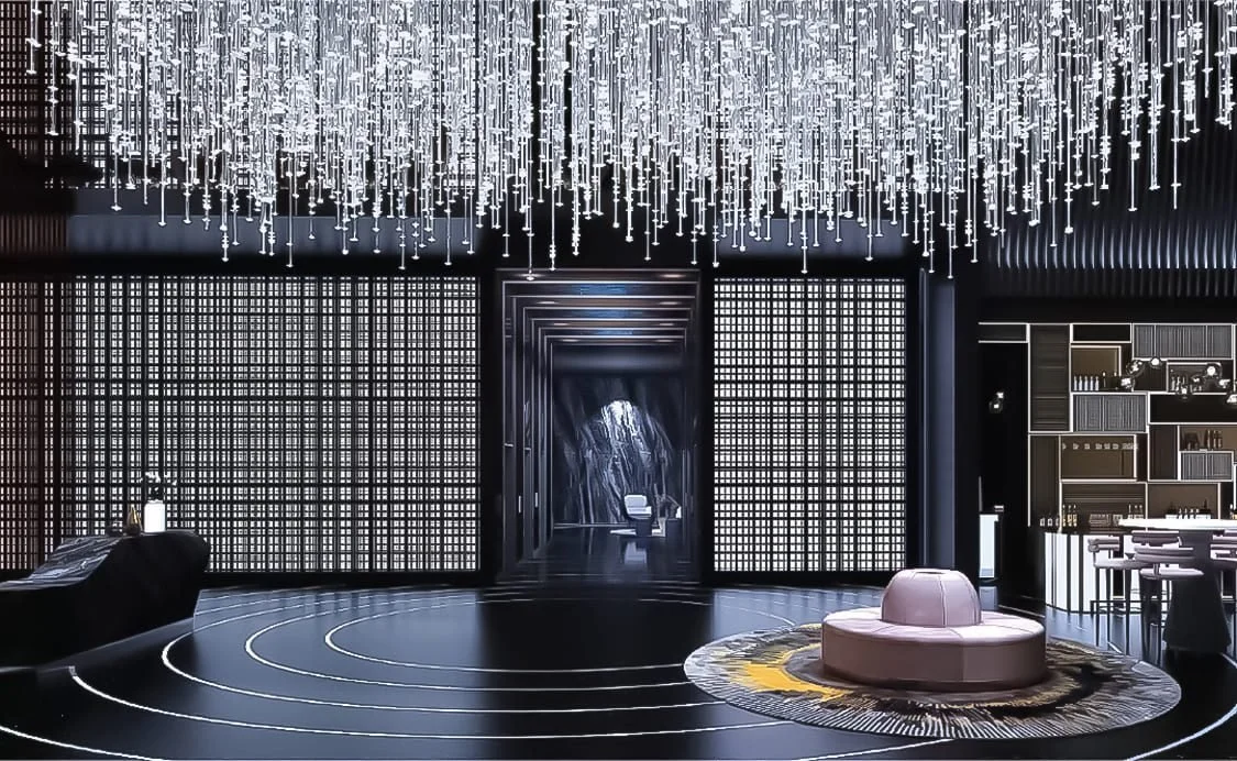 Grand lobby of Orion Residence featuring a chandelier ceiling and contemporary dark-tone décor.