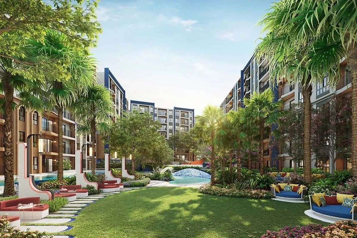 Landscaped palm courtyard at Cabanas Hua Hin with lawns, tropical planting and outdoor seating.