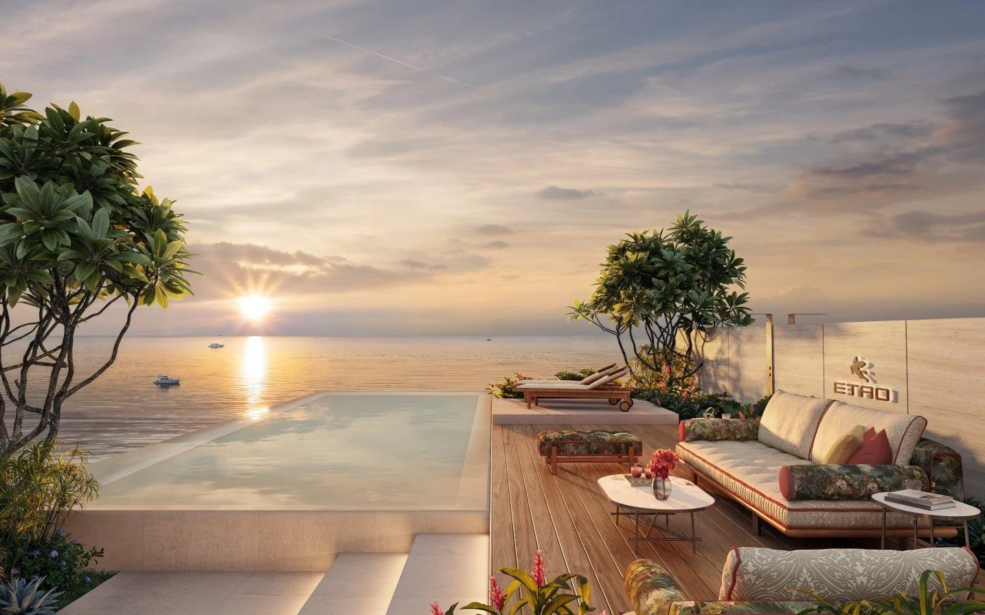 Rooftop infinity pool and terrace at Etro Residences, Gardens of Eden Phuket, overlooking the sea at sunset with lounge seating.