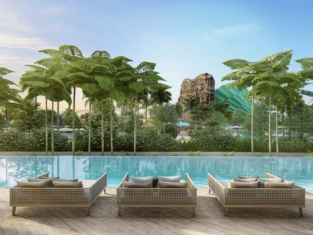 Poolside lounge area at Vehha Hua Hin overlooking landscaped gardens and nearby water park in Hua Hin, Thailand.