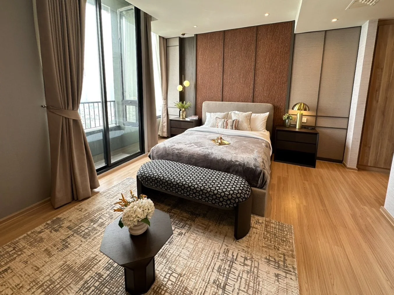 Bedroom at Noble Form Thonglor with double bed, balcony access and city views.