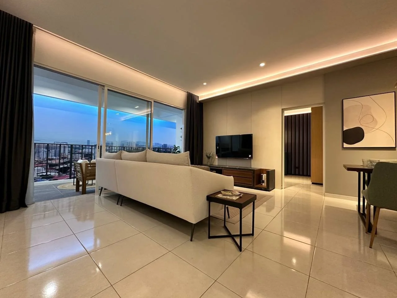 Waterstone Penang show unit living room with balcony access and city-facing outlook.