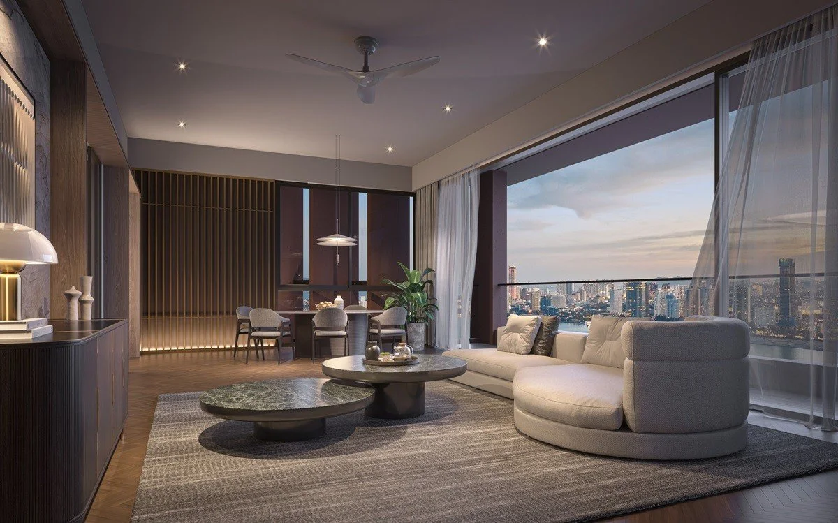 Living room at The Lume by E&O with floor-to-ceiling glazing and evening city views across Penang.