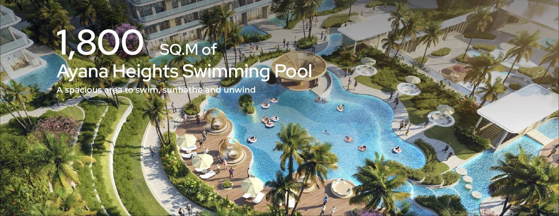 Aerial view of Ayana Heights’ 1,800 sqm resort-style swimming pool in Phuket, surrounded by palm trees, loungers, and landscaped walkways