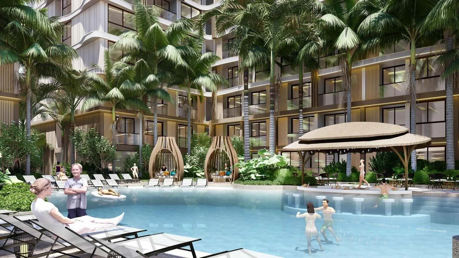 Family swimming pool area with sun loungers, swim up bar and palm trees at VIP Tropika Phuket.