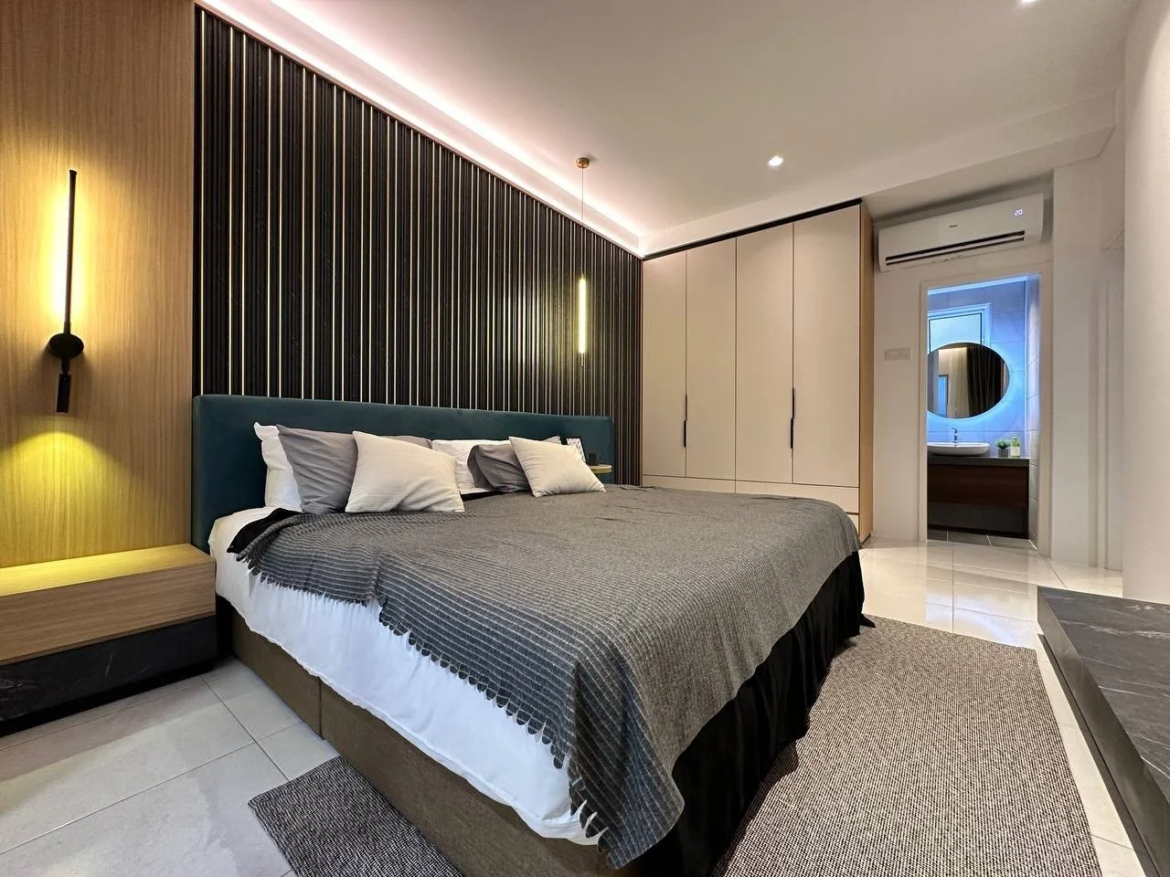 Waterstone Penang show unit bedroom with built-in wardrobes and en suite bathroom access.