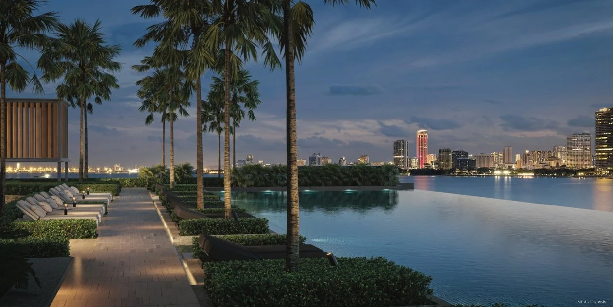 Infinity pool overlooking Penang skyline and waterfront at night.