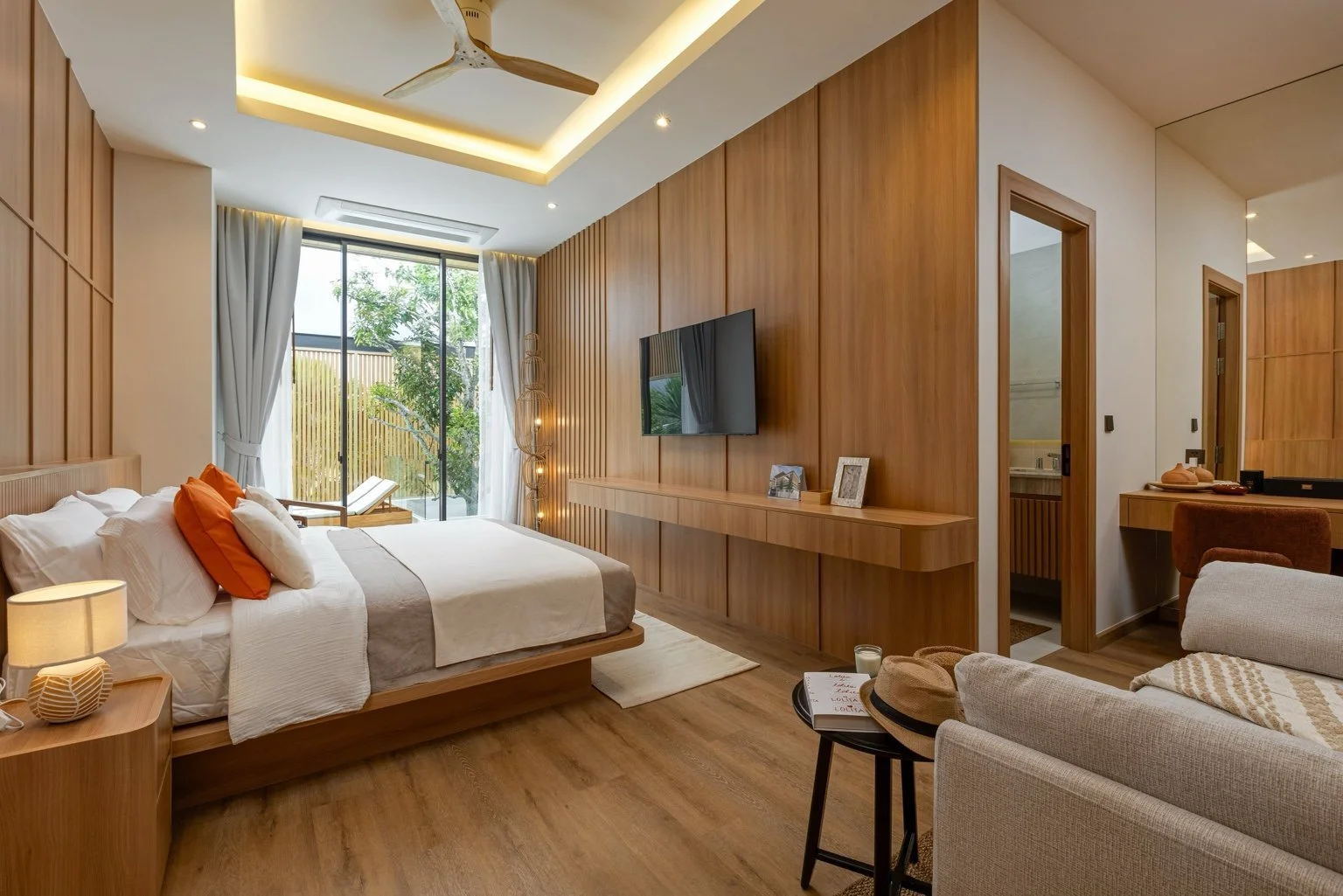 Master bedroom suite at Mouana Grande Chalong Bay with floor-to-ceiling windows and pool access.