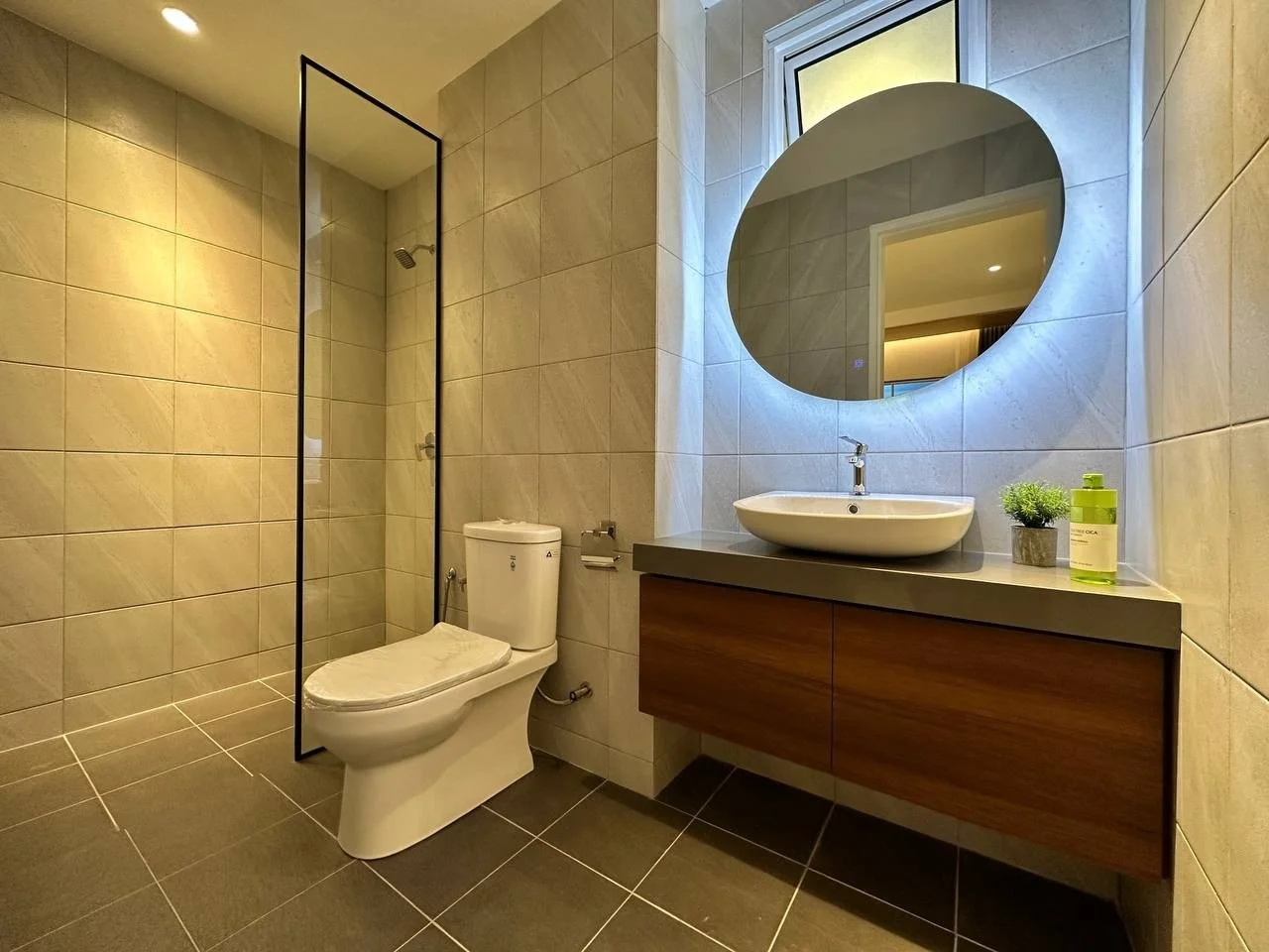 Waterstone Penang show unit bathroom with walk-in shower, vanity and illuminated mirror.