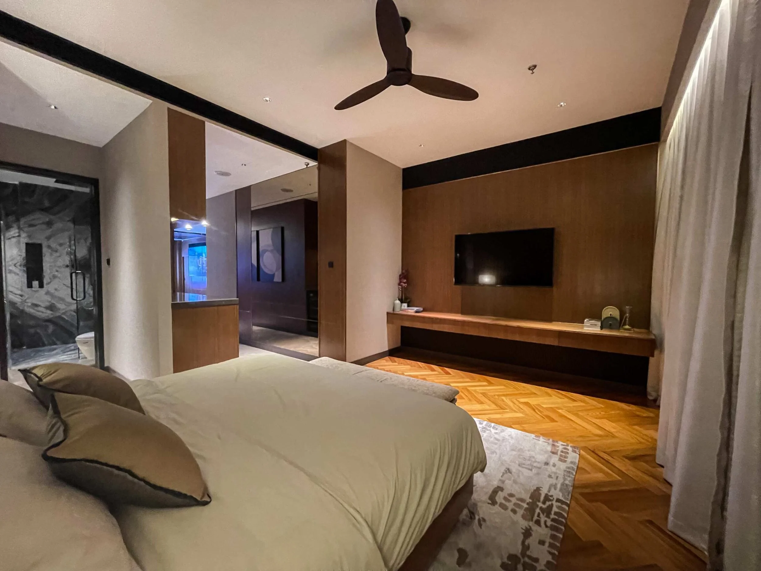 Modern master suite at Orion Residence with timber floors, en-suite, and minimalist décor.
