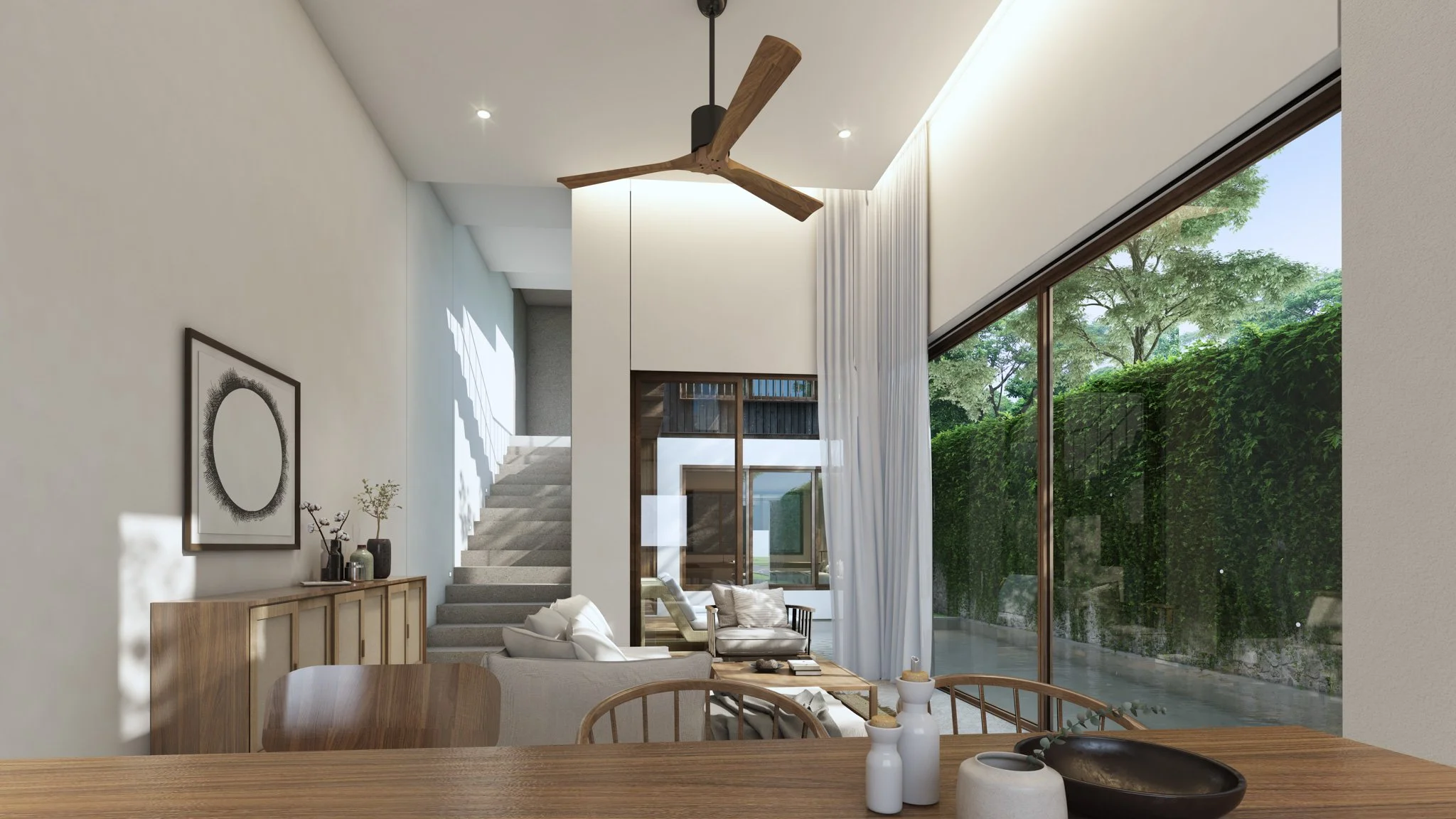 Bright and airy living room with double-height ceilings in the Pine villa at Villa Qabalah, featuring floor-to-ceiling glass and garden views