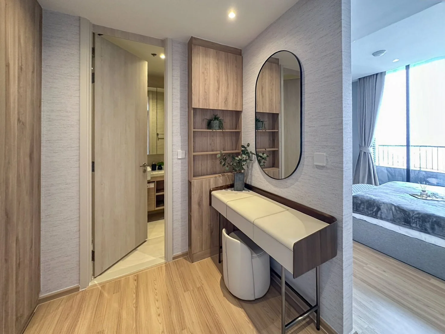 Dressing area with mirror and storage at Noble Form Thonglor leading to bedroom.