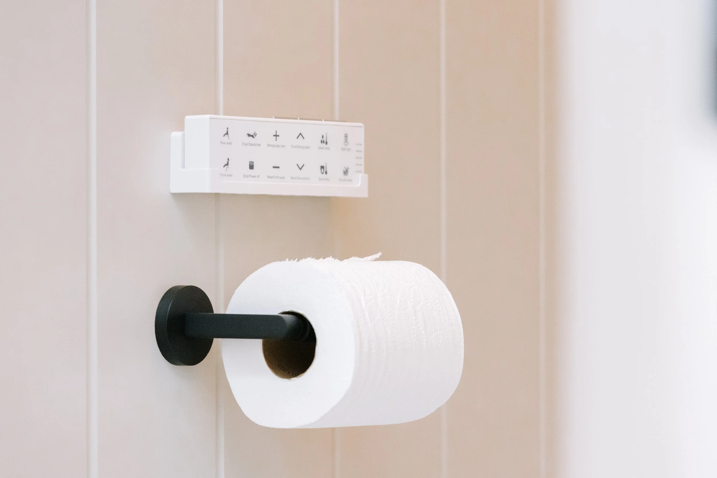 wall-mounted-toilet-paper-holder-with-bidet-controls.jpg