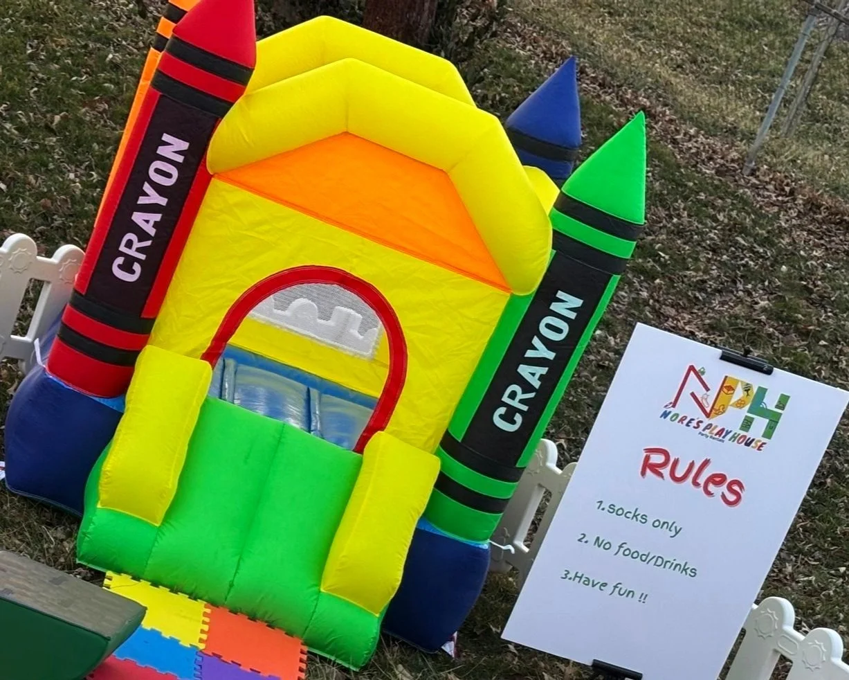 Colorful crayon-themed inflatable bounce house.