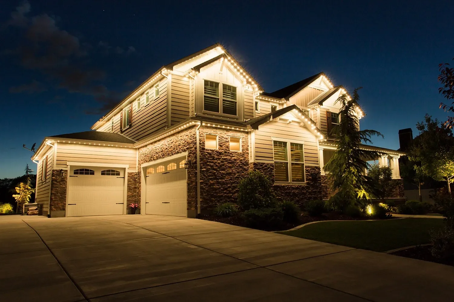 Professional permanent lighting installation on a modern home in Bismarck – residential exterior lighting service
